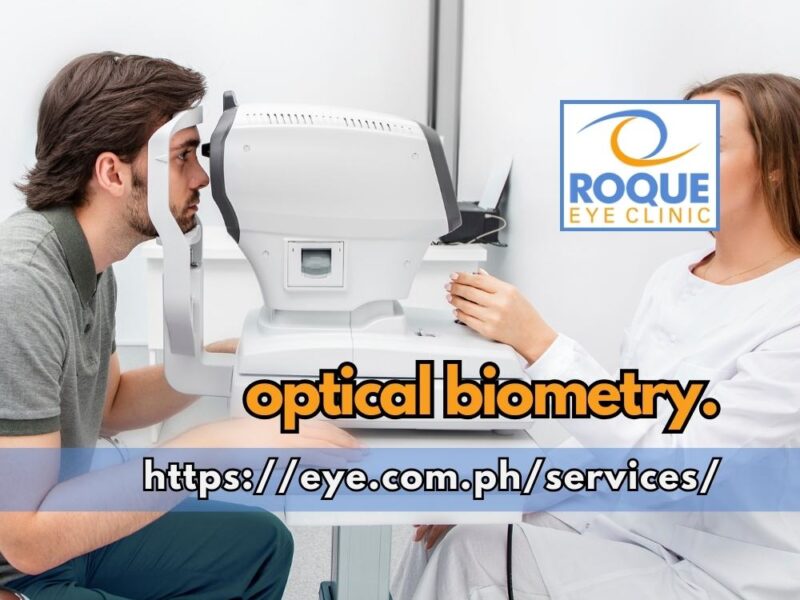 This image shows a technician performing optical biometry on a seated patient.
